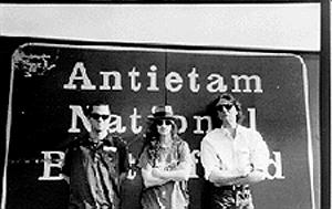 Tim, Tara and Josh in front of a sign